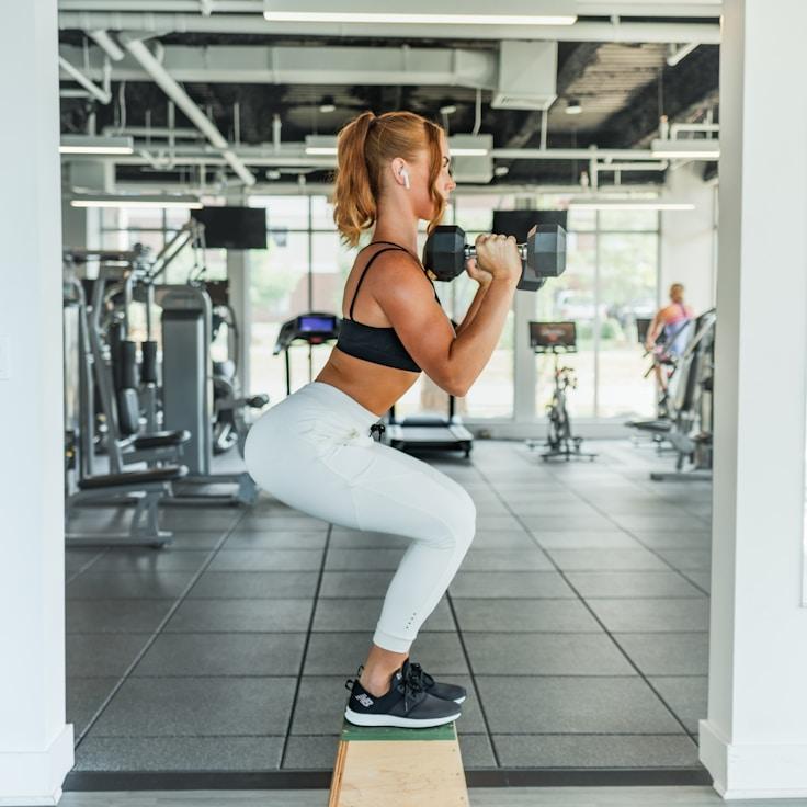 Women in a fitness class doing stretching and mobility exercises